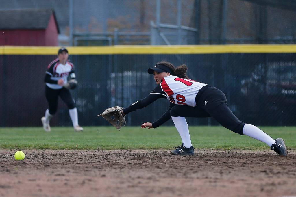 Snohomishs Emma Hansen makes a diving play at shortstop before throwing out a runner at second base to end an inning against Arlington Tuesday, April 19, 2022, at Snohomish High School in Snohomish, Washington. (Ryan Berry / The Herald)