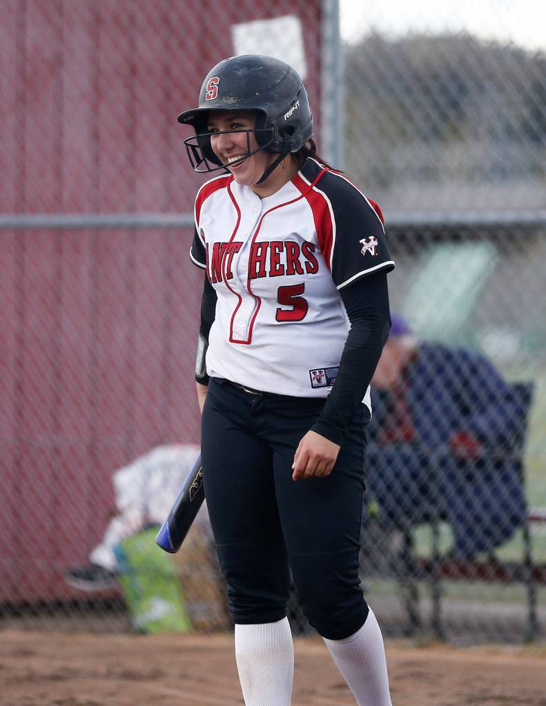 Snohomish leadoff batter Alli Wilson laughs after fouling off consecutive pitches against Arlington Tuesday, April 19, 2022, at Snohomish High School in Snohomish, Washington. (Ryan Berry / The Herald)