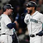 The Mariners Abraham Toro (right) celebrates with Tom Murphy after Toro hit a two-run home run during the seventh inning of a game against the Rangers on Tuesday in Seattle. (AP Photo/Ted S. Warren)
