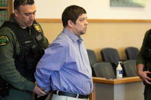 David Nieuwenhuis is handcuffed by a deputy after being convicted of second-degree murder on Tuesday, April 26, 2022, at Snohomish County Court in Everett, Washington. (Ryan Berry / The Herald)