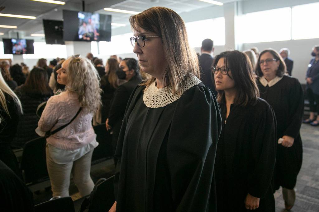 Local judges, some wearing collars to honor Cassandra Lopez-Shaws memory, exit the room after the memorial for her Thursday at the Snohomish County Courthouse in Everett. (Ryan Berry / The Herald)