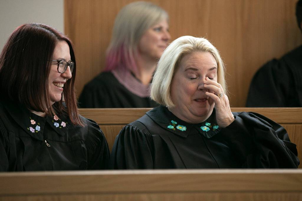Judges laugh and cry while listening to a speaker during the memorial for Judge Cassandra Lopez-Shaw Thursday at the Snohomish County Courthouse in Everett. (Ryan Berry / The Herald)