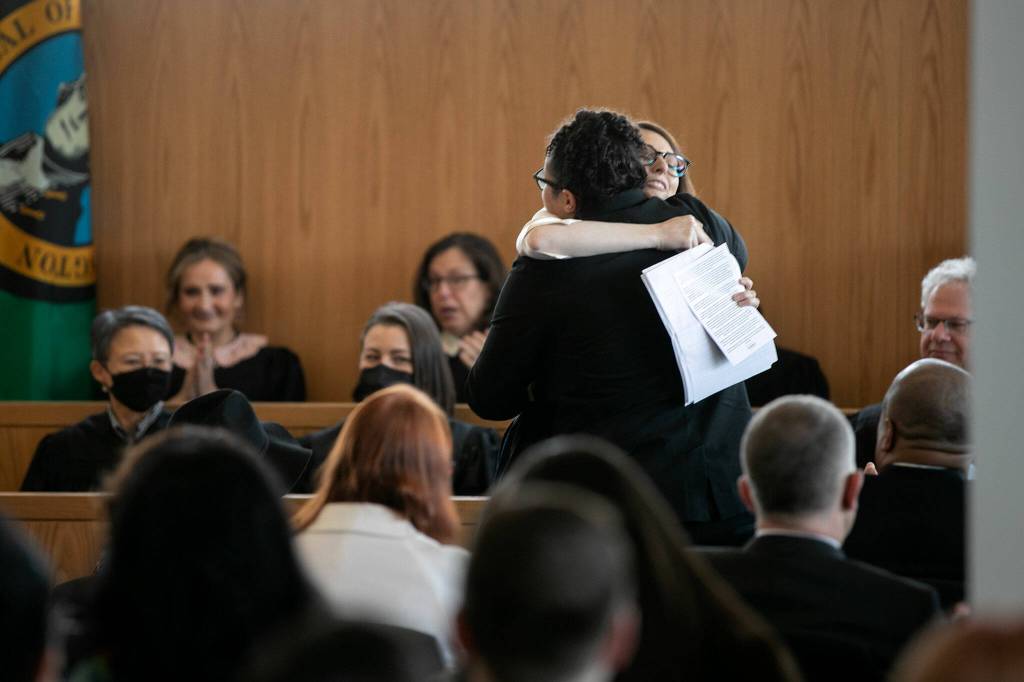 Laura Shaver hugs a member of the Lopez-Shaw family after giving a speech about her friend during the memorial for Judge Cassandra Lopez-Shaw Thursday at the Snohomish County Courthouse in Everett. (Ryan Berry / The Herald)