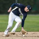 Arlingtons Aiden Green picks up a ground ball during the game against Monroe on Thursday, April 21, 2022 in Arlington, Washington. (Olivia Vanni / The Herald)