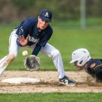 Arlingtons Tyler Rusko catches a ground ball while Monroes Kody Edelbrock slides into second base during the game on Thursday, April 21, 2022 in Arlington, Washington. (Olivia Vanni / The Herald)