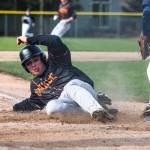 Monroes Shaun Cushman slides into home plate to score during the game against Arlington on Thursday, April 21, 2022 in Arlington, Washington. (Olivia Vanni / The Herald)