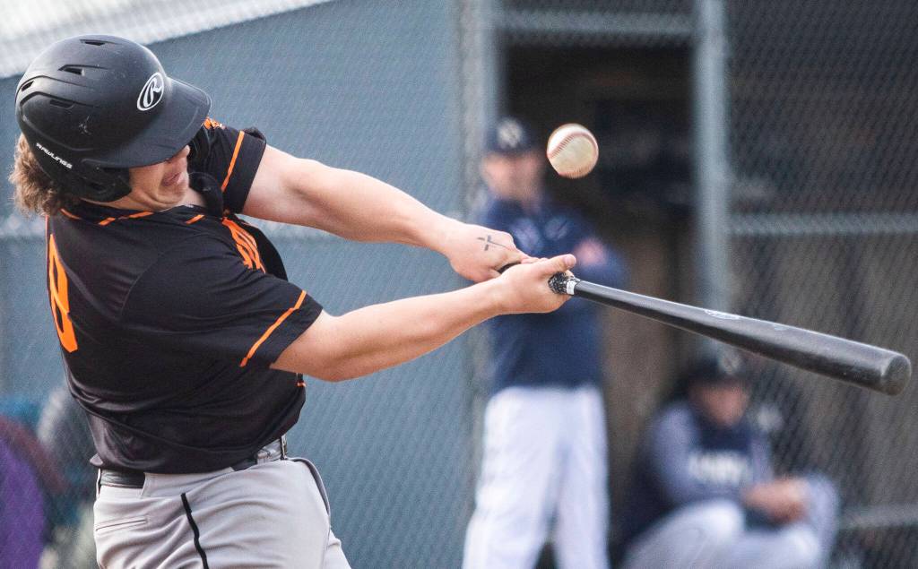 Monroes Rylan Hampton hits the ball during the game against Arlington on Thursday, April 21, 2022 in Arlington, Washington. (Olivia Vanni / The Herald)