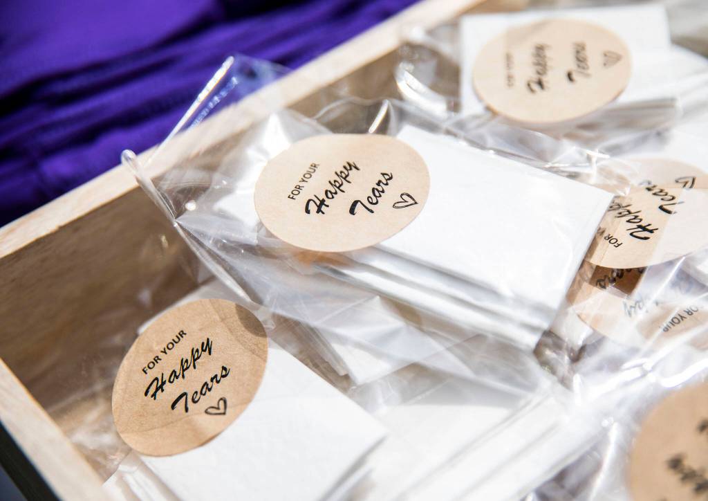 Small packets of tissues for happy tears sit on a table for friends and family to use on Saturday, April 23, 2022 in Bothell, Washington. (Olivia Vanni / The Herald)