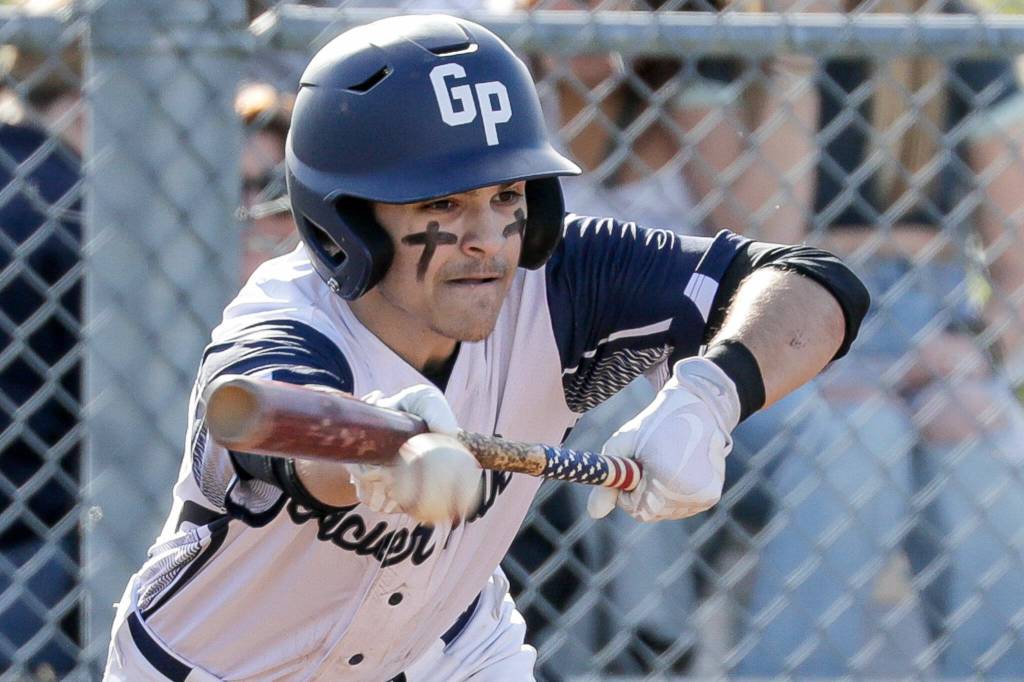 Glacier Peak's Eli Groves bunts against Jackson Friday afternoon at Glacier Peak High School in Snohomish, Washington on April 22, 2022. The Timberwolves won 12-4. (Kevin Clark / The Herald)