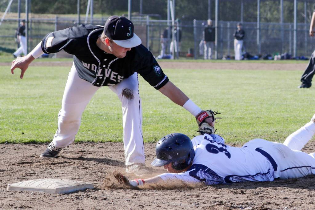 Jackson first baseman Jaggar Endresen tags out Glacier Peaks Logan Hall to complete a key strikeout-throwout double play. (Kevin Clark / The Herald)
