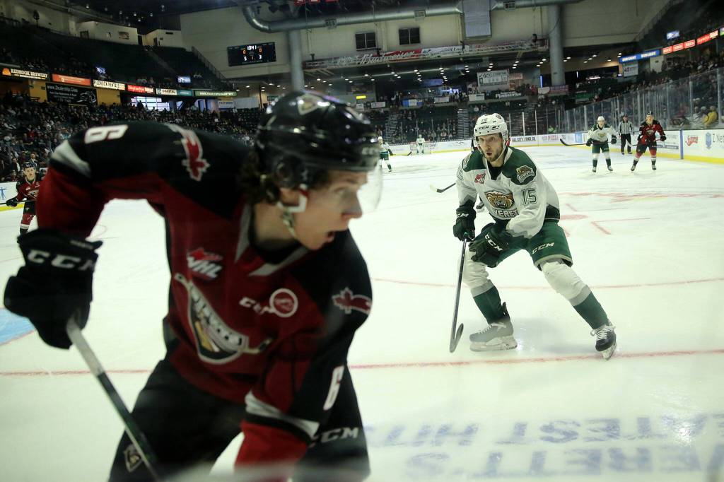 The Everett Silvertips&rsquo; Ryan Hofer prepares to slam an opponent into the glass against the Vancouver Giants during the first round of the WHL playoffs Friday, April 22, 2022, at Angel of the Winds Arena in Everett, Washington. (Ryan Berry / The Herald)
