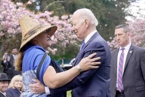 President Joe Biden talks with Teri Gobin, Chairwoman, Tulalip Tribes, after signing an executive order intended to help restore national forests devastated by wildfires, drought and blight, during an event at Seward Park on Earth Day, Friday, April 22, 2022, in Seattle. (AP Photo/Andrew Harnik)