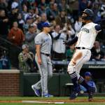 The Mariners Julio Rodriguez (right) scores on a triple by Jarred Kelenic during the fourth inning of a game against the Royals on Friday in Seattle. (AP Photo/Jason Redmond)