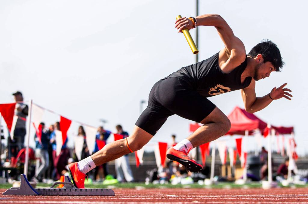 A Lynnwood runner in the boys 4x100 relay takes off the starting block during Eason Invitational track and field meet on Saturday, April 23, 2022 in Snohomish, Washington. (Olivia Vanni / The Herald)