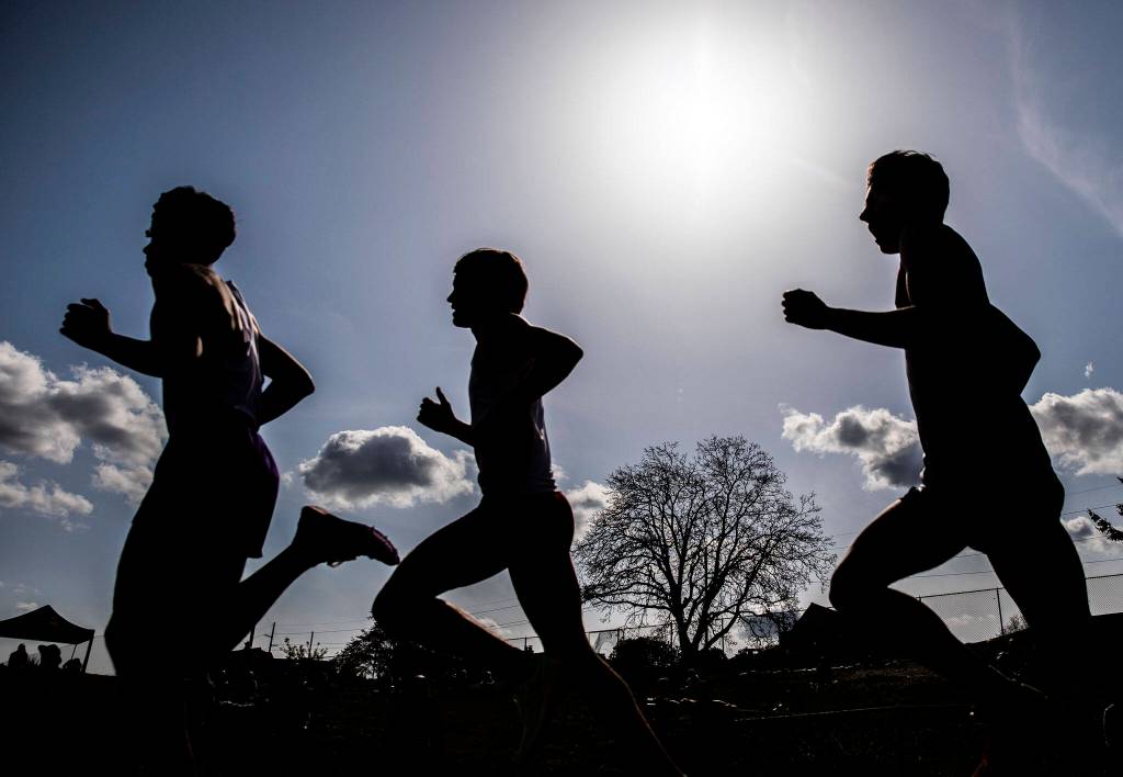 Runners compete in the boys 1,600 meters. (Olivia Vanni / The Herald)