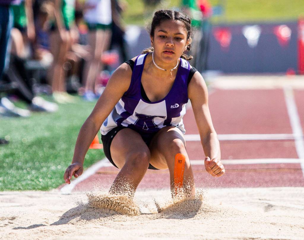 A Kamiak triple jumper lands her jump during Eason Invitational track and field meet on Saturday, April 23, 2022 in Snohomish, Washington. (Olivia Vanni / The Herald)