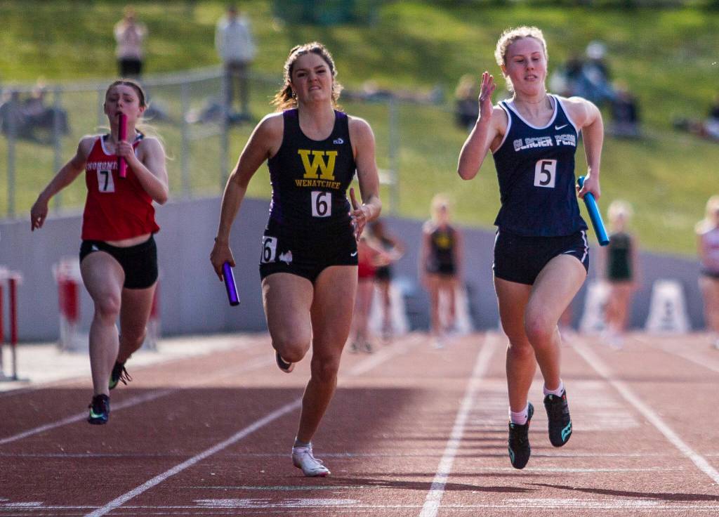 Runners compete in the 4x100 relay during Eason Invitational track and field meet on Saturday, April 23, 2022 in Snohomish, Washington. (Olivia Vanni / The Herald)