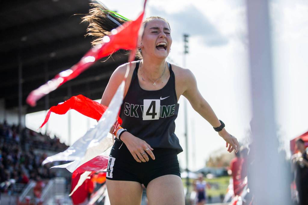 A Skyline runner reacts to winning the girls 1,600 meter during Eason Invitational track and field meet on Saturday, April 23, 2022 in Snohomish, Washington. (Olivia Vanni / The Herald)