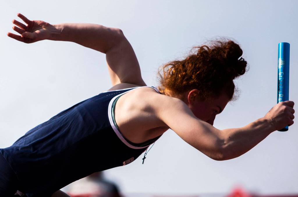A Glacier Peak runner in the girls 4x100 relay takes off the starting blocks during Eason Invitational track and field meet on Saturday, April 23, 2022 in Snohomish, Washington. (Olivia Vanni / The Herald)