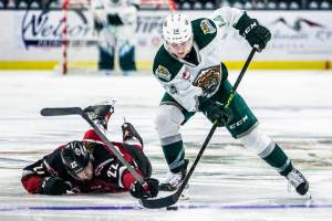 Silvertips' Austin Roest trips up Giants' Connor Homing after a breakaway during the playoff match up against the Vancouver Giants on Saturday, April 23, 2022 in Everett, Washington. (Olivia Vanni / The Herald)