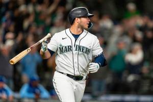 Seattle Mariners' Ty France flips his bat after hitting a three-run home run that scored Julio Rodriguez and Jesse Winker off of Kansas City Royals relief pitcher Dylan Coleman during the eighth inning of a baseball game, Saturday, April 23, 2022, in Seattle. The Mariners won 13-7. (AP Photo/Stephen Brashear)