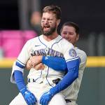 Seattle Mariners' Jesse Winker, front right, is lifted by Ty France as he celebrates a win over Kansas City Royals in 12 innings of a baseball game, Sunday, April 24, 2022, in Seattle. (AP Photo/John Froschauer)