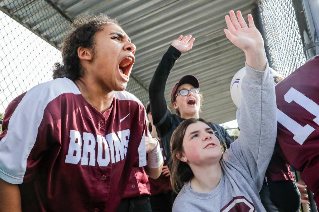Cascade players cheer in the dugout. (Kevin Clark / The Herald)