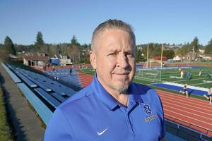 Joe Kennedy, a former assistant football coach at Bremerton High School in Bremerton, Wash., poses for a photo March 9, 2022, at the school's football field. After losing his coaching job for refusing to stop kneeling in prayer with players and spectators on the field immediately after football games, Kennedy will take his arguments before the U.S. Supreme Court on Monday, April 25, 2022, saying the Bremerton School District violated his First Amendment rights by refusing to let him continue praying at midfield after games. (AP Photo/Ted S. Warren)