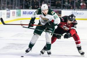 Silvertips’ Niko Huuhtanen and Giants’ Jaden Lipinski fight for the puck during the playoff match up against the Vancouver Giants on Saturday, April 23, 2022 in Everett, Washington. (Olivia Vanni / The Herald)