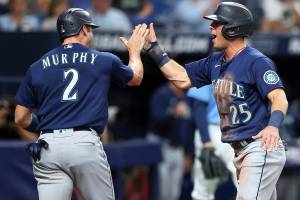 Seattle Mariners' Dylan Moore (25) celebrates with Tom Murphy as both score against the Tampa Bay Rays during the fourth inning of a baseball game Tuesday, April 26, 2022, in St. Petersburg, Fla. (AP Photo/Mike Carlson)