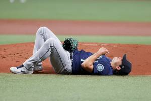 Seattle Mariners starting pitcher Marco Gonzales reacts on the ground after being by an infield single from Tampa Bay Rays' Harold Ramirez during first inning of a baseball game Wednesday, April 27, 2022, in St. Petersburg, Fla. (AP Photo/Scott Audette)