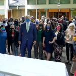 Washington Gov. Jay Inslee, center, reacts after he signed a bill into law in Tukwila, Wash., Tuesday, May 4, 2021, that levies a new capital gains tax on high profit stocks, bonds and other assets for some residents of Washington state. (AP Photo/Ted S. Warren)