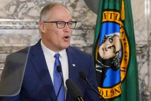 Washington Gov. Jay Inslee speaks as he gives his annual State of the State address, Tuesday, Jan. 11, 2022, at the Capitol in Olympia, Wash. Due to cautions against COVID-19, Inslee gave his speech in the State Reception Room and it was shown by streaming video to lawmakers meeting remotely. (AP Photo/Ted S. Warren)