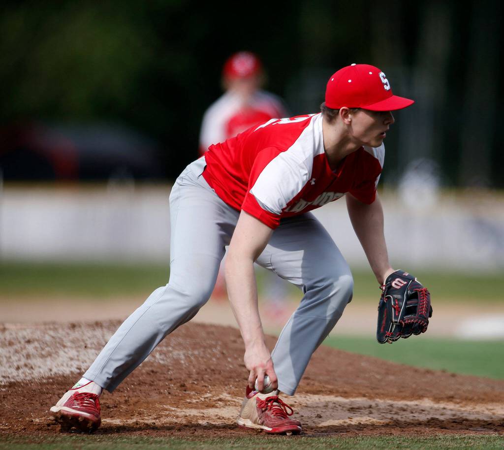 Stanwoods Mason Goodson makes a play after getting hit with a comebacker against Archbishop Murphy Thursday, April 28, 2022, at Archbishop Murphy High School in Everett, Washington. (Ryan Berry / The Herald)