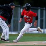 Archbishop Murphy scores a run on a hit against Stanwood Thursday, April 28, 2022, at Archbishop Murphy High School in Everett, Washington. (Ryan Berry / The Herald)