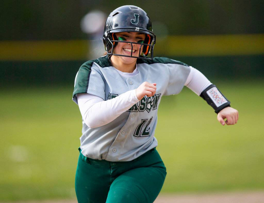 Jacksons Kaila Zellmer smiles while rounding third base after hitting a home run during the game against Glacier Peak on Thursday, April 28, 2022 in Everett, Washington. (Olivia Vanni / The Herald)