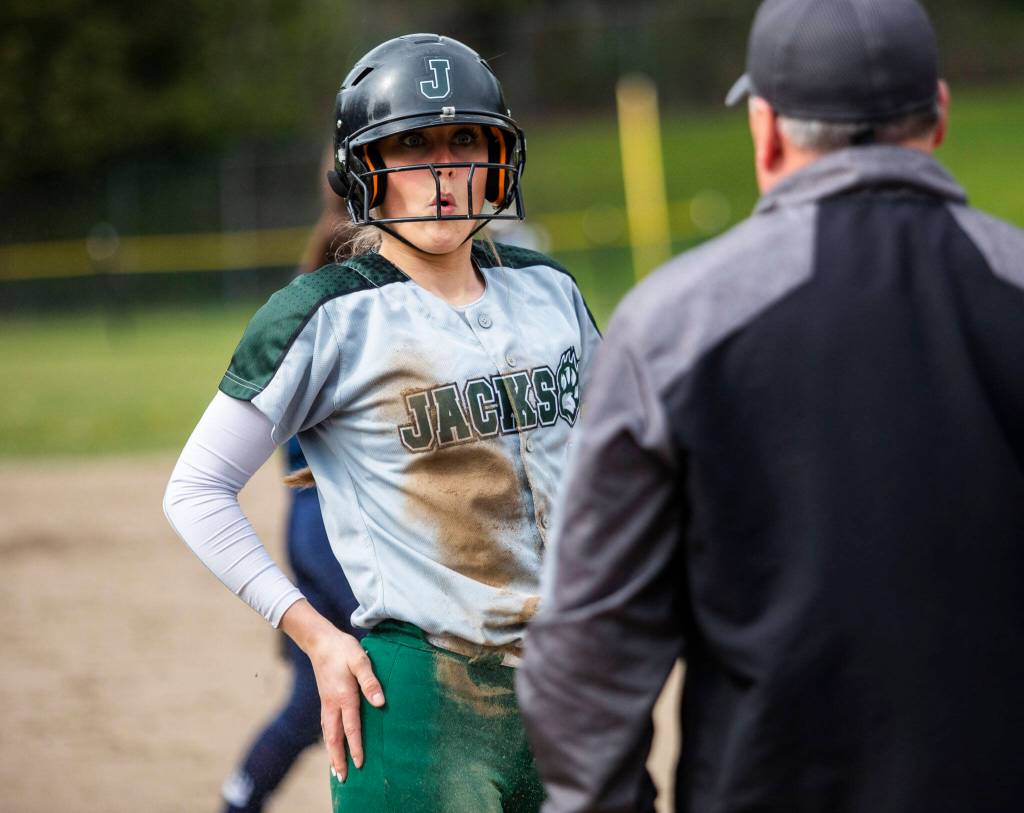 Jacksons Avery Olson reacts to barely being safe at third base after running because of an overthrown ball to second base during the game against Glacier Peak on Thursday, April 28, 2022 in Everett, Washington. (Olivia Vanni / The Herald)