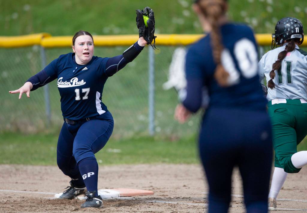 Glacier Peaks Natalie Dimitro reaches out to catch the ball for an out at first base during the game against Jackson on Thursday, April 28, 2022 in Everett, Washington. (Olivia Vanni / The Herald)