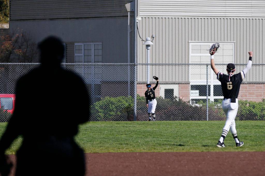 Lynnwoods Sergio Navarro holds up the ball after making a leaping catch in the outfield against Meadowdale Friday, April 29, 2022, at Meadowdale High School in Lynnwood, Washington. (Ryan Berry / The Herald)