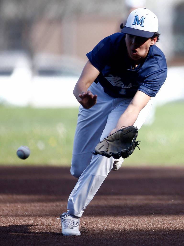 Meadowdale second baseman Zaid Flynn scoops up a grounder before throwing out the runner. (Ryan Berry / The Herald)