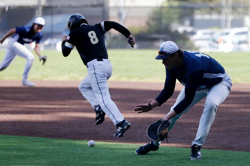 Meadowdale first baseman Brandon Brunette fields a ground ball. (Ryan Berry / The Herald)