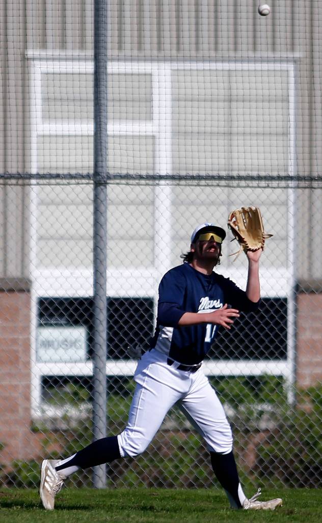Meadowdales Johnathon OConnell grabs a fly ball to left field against Lynnwood Friday, April 29, 2022, at Meadowdale High School in Lynnwood, Washington. (Ryan Berry / The Herald)