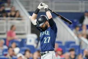 Seattle Mariners' Jesse Winker reacts after je struck out swinging during the third inning of a baseball game against the Miami Marlins, Friday, April 29, 2022, in Miami. (AP Photo/Wilfredo Lee)