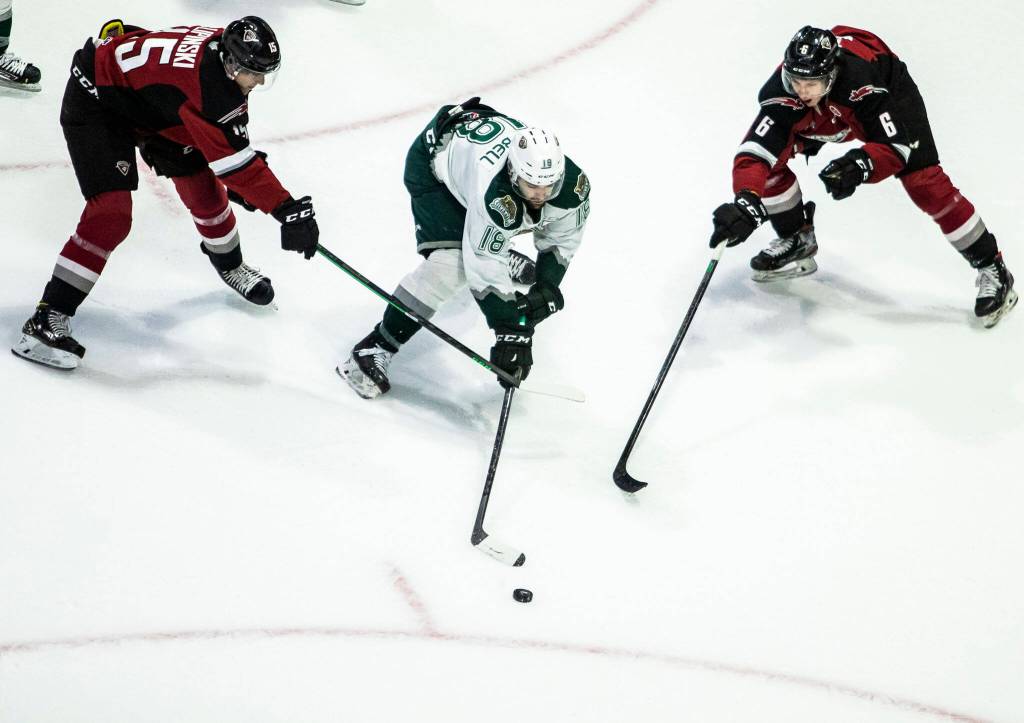 Silvertips Hunter Campbell is slashed by Giants Jaden Lipinski during the game against the Giants on Saturday, April 30, 2022 in Everett, Washington. (Olivia Vanni / The Herald)