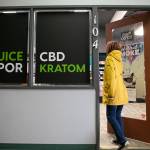 A customer enters Island Smoke at Kens Korner shopping plaza in Clinton on Whidbey Island. (Ryan Berry / The Herald)