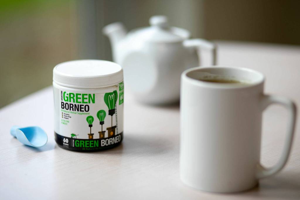 A container of kratom powder sits alongside a mug of prepared tea Friday, May 13, 2022, in Everett, Washington. (Ryan Berry / The Herald)