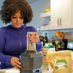 Rainey Forzetting makes a kratom smoothie at her home in Lake Stevens. Blueberries, a triple berry mix, almond butter, pomegranate, oat milk and 6 grams of kratom make up her morning concoction. (Kevin Clark / The Herald)