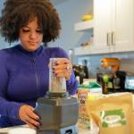 Rainey Forzetting makes a kratom smoothie at her home in Lake Stevens, Washington on March 29, 2022. Blueberries, 6 grams Kratom, a triple berry mix, almond butter, pomegranate and oak milk make up her daily concoction. (Kevin Clark / The Herald)