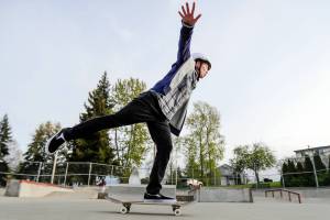 Aly Richards warms up during a skateboard workshop Thursday evening at Wiggum Hollows Park in Everett, Washington on April 28, 2022.  (Kevin Clark / The Herald)