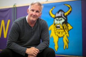 Brent Barnes, who coached Lake Stevens High School wrestling for more than three decades, sits in the school’s wrestling room Tuesday, April 12, 2022, in Lake Stevens, Washington. (Ryan Berry / The Herald)